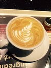 Flat white coffee with pretty feather pattern.jpg