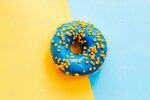 blue-yellow-glaze-donut-on-blue-yellow-paper-photo.JPG
