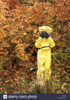 43-year-old-asian-male-in-a-hazmat-suit-and-gas-mask-outdoors-with-B62G52.jpg