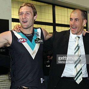 jay-schulz-and-warren-tredrea-of-the-power-celebrate-in-the-change-rooms-after-the-round-18.jpg
